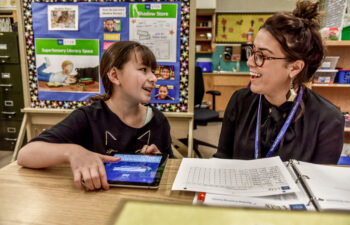 Student & Mentor Laughing in the Classroom, learning disability school programs