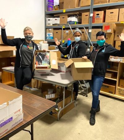 New Relic team members having fun while packing supplies for students