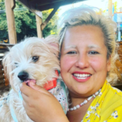 Olivia smiling and holding a terrier chihuahua