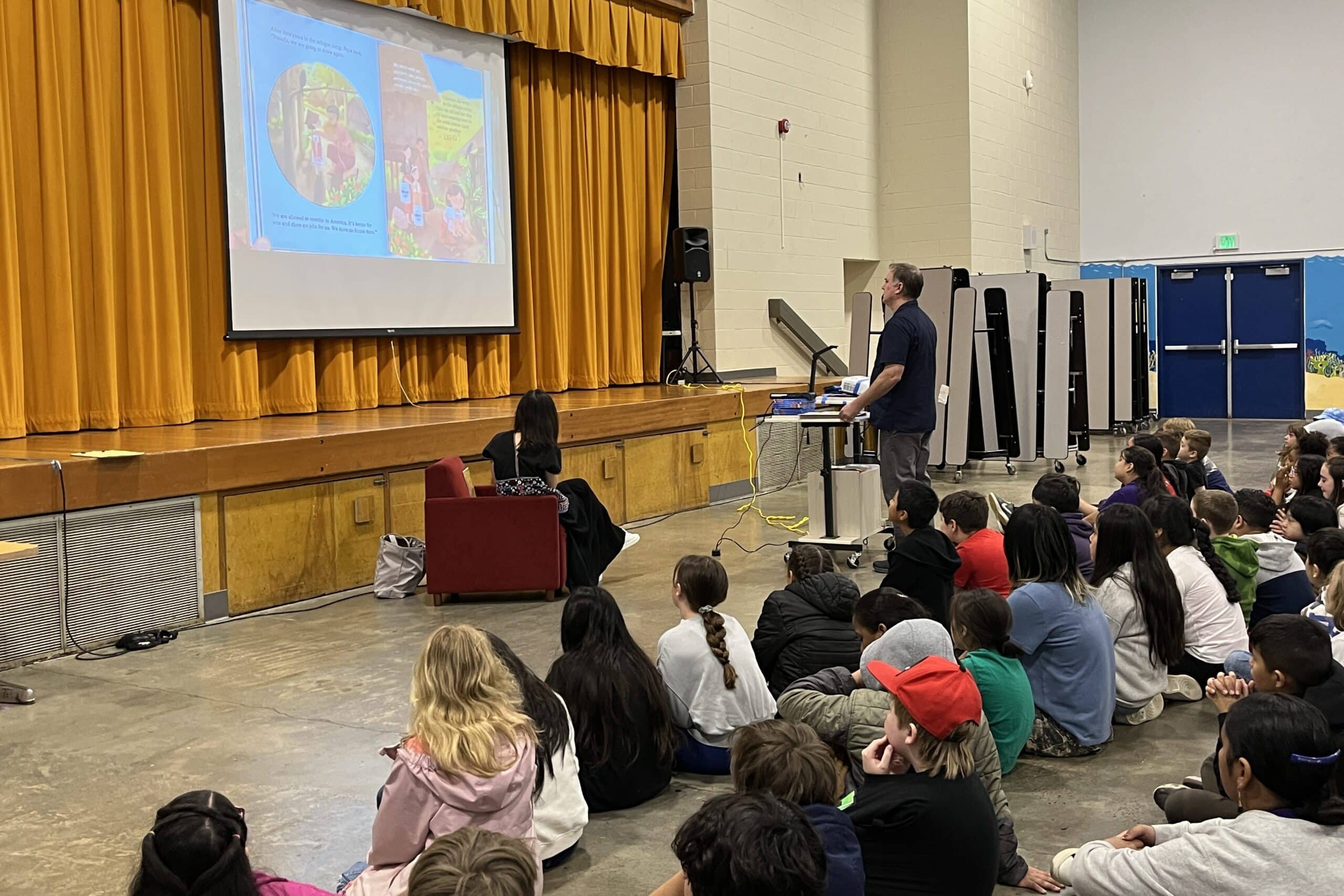 Reading Mentor Program Spring Celebration. Students listening to author speak