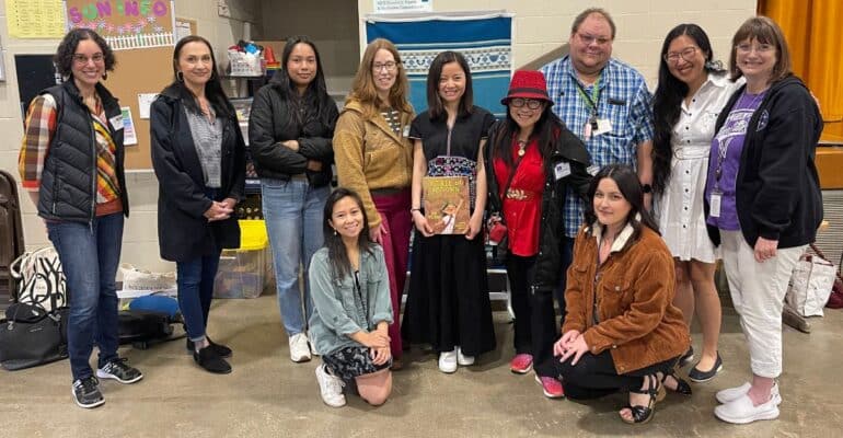 The Shadow Project staff posing in a group photo with author Nui Wilson.