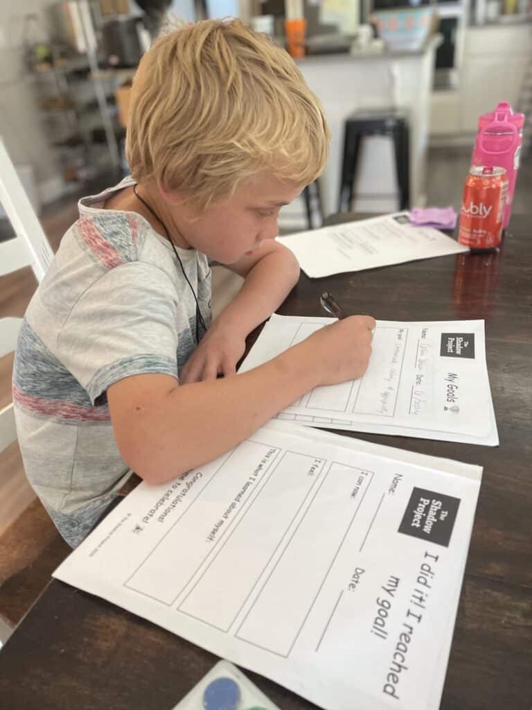 child working on summer goal setting worksheets