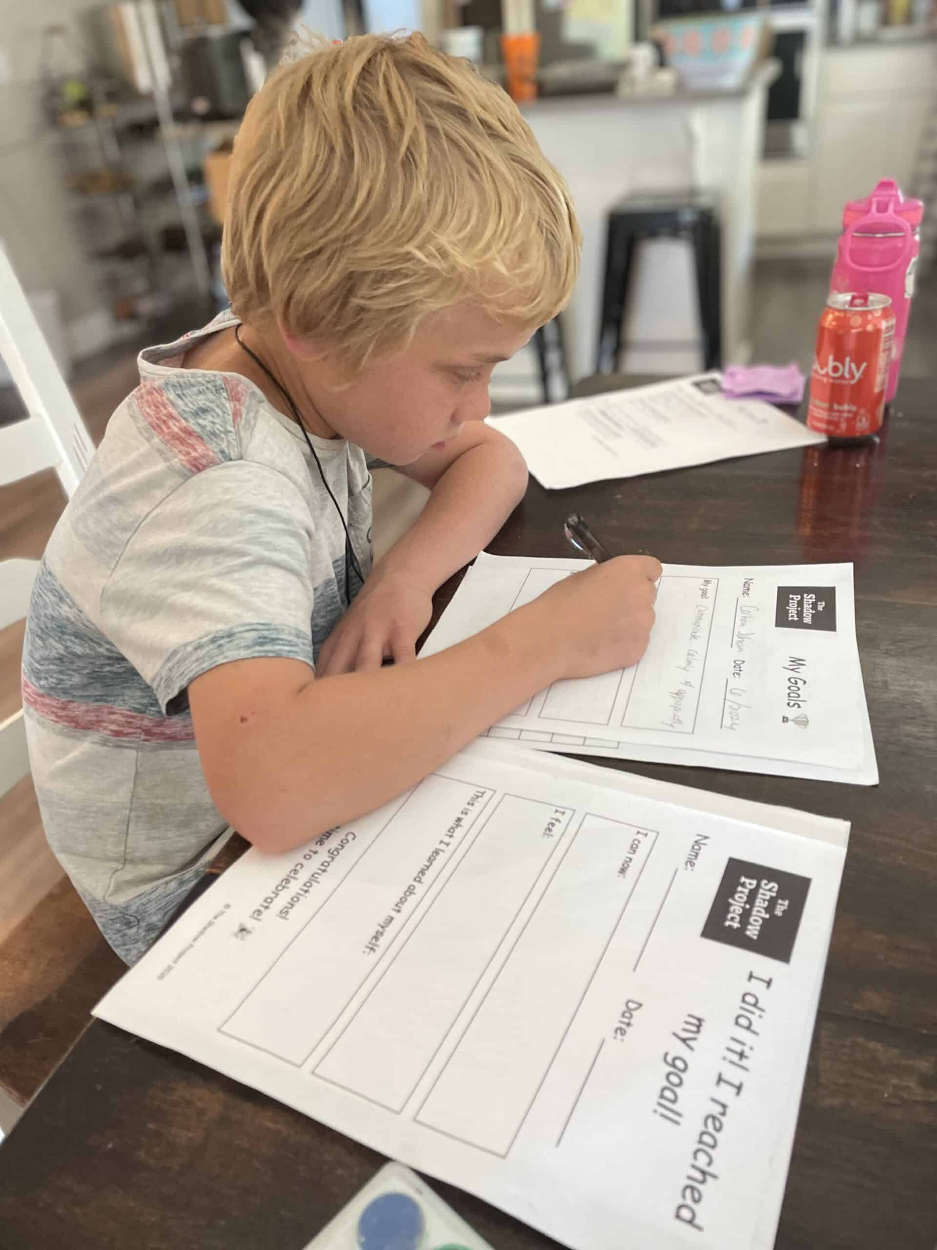 child working on summer goal setting worksheets