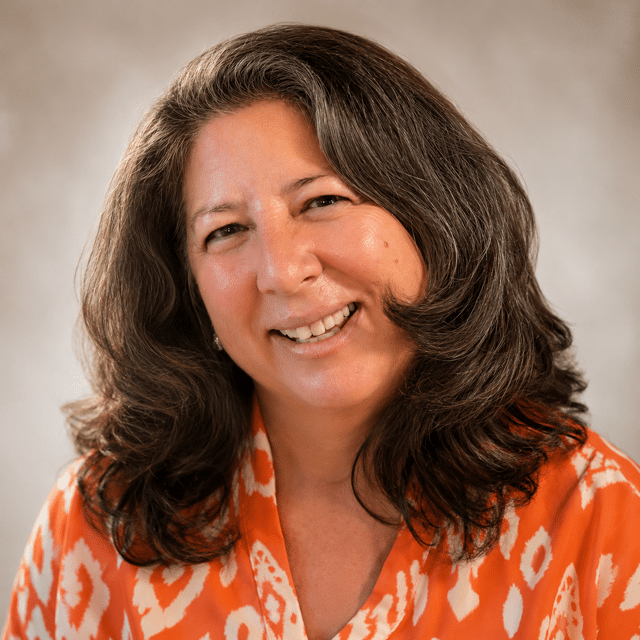 a woman with brown hair smiling