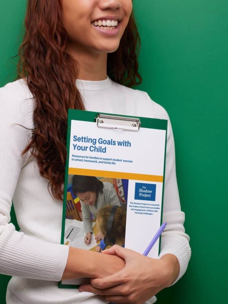 a woman holding a clipboard with the goal setting resource on it